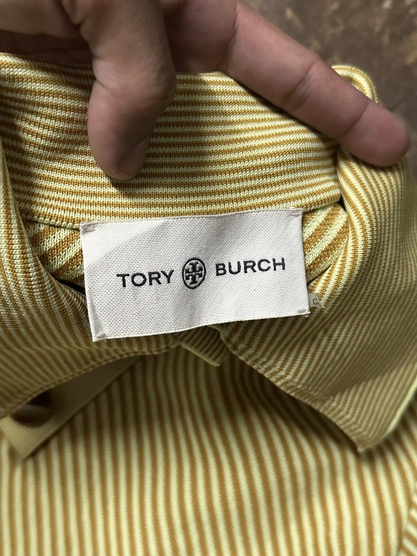 Tory Burch Striped Polo Shirt (Category: Shirts) located in Padada. Submitted by jevanie1234 (Listing ID 1462545136, Image 3). Description: - Tory Burch Polo Shirt - Size: XS - Design: Striped pattern - Features: Collar, button details - Branding: Embroidered Tory Burch logo on sleeve - Origin: Made in China.