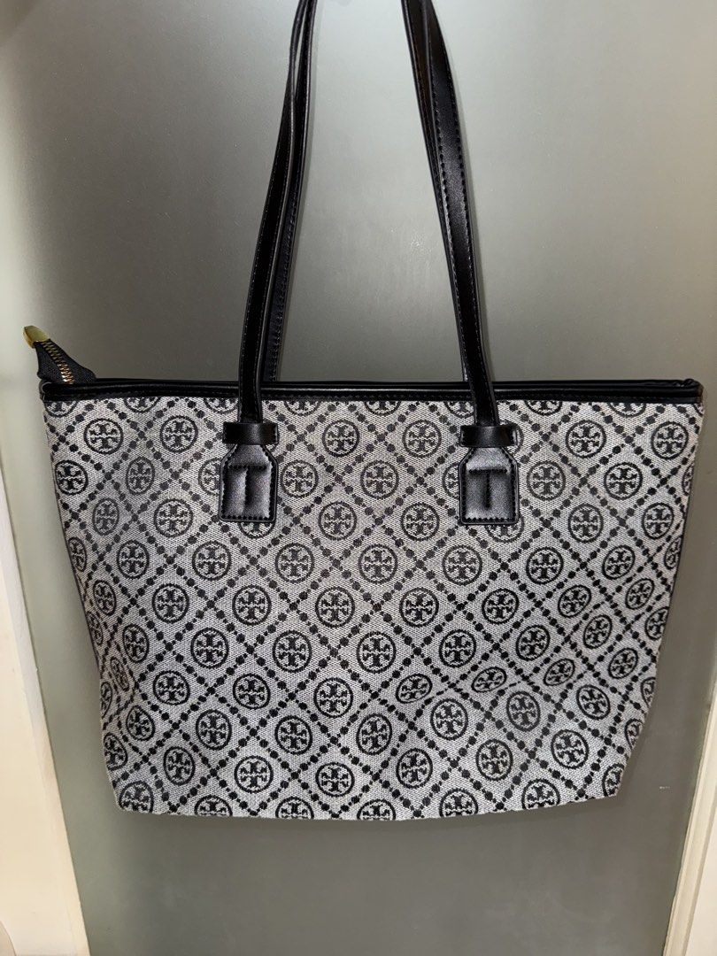 Tory Burch Tote Bag (Category: Luxury Bags & Wallets) located in Makati City. Submitted by amos411 (Listing ID 1462461485, Image 2). Description: Tory Burch Monogram Tote Bag Not OG Size: Large Color: Black Can fit 11-13inch ipad or laptop RFS: decluttering.
