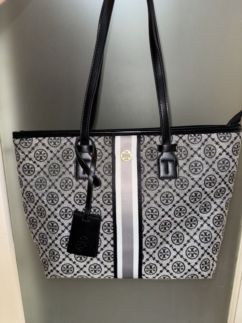 Tory Burch Tote Bag (Category: Luxury Bags & Wallets) located in Makati City. Submitted by amos411 (Listing ID 1462461485, Image 1). Description: Tory Burch Monogram Tote Bag Not OG Size: Large Color: Black Can fit 11-13inch ipad or laptop RFS: decluttering.