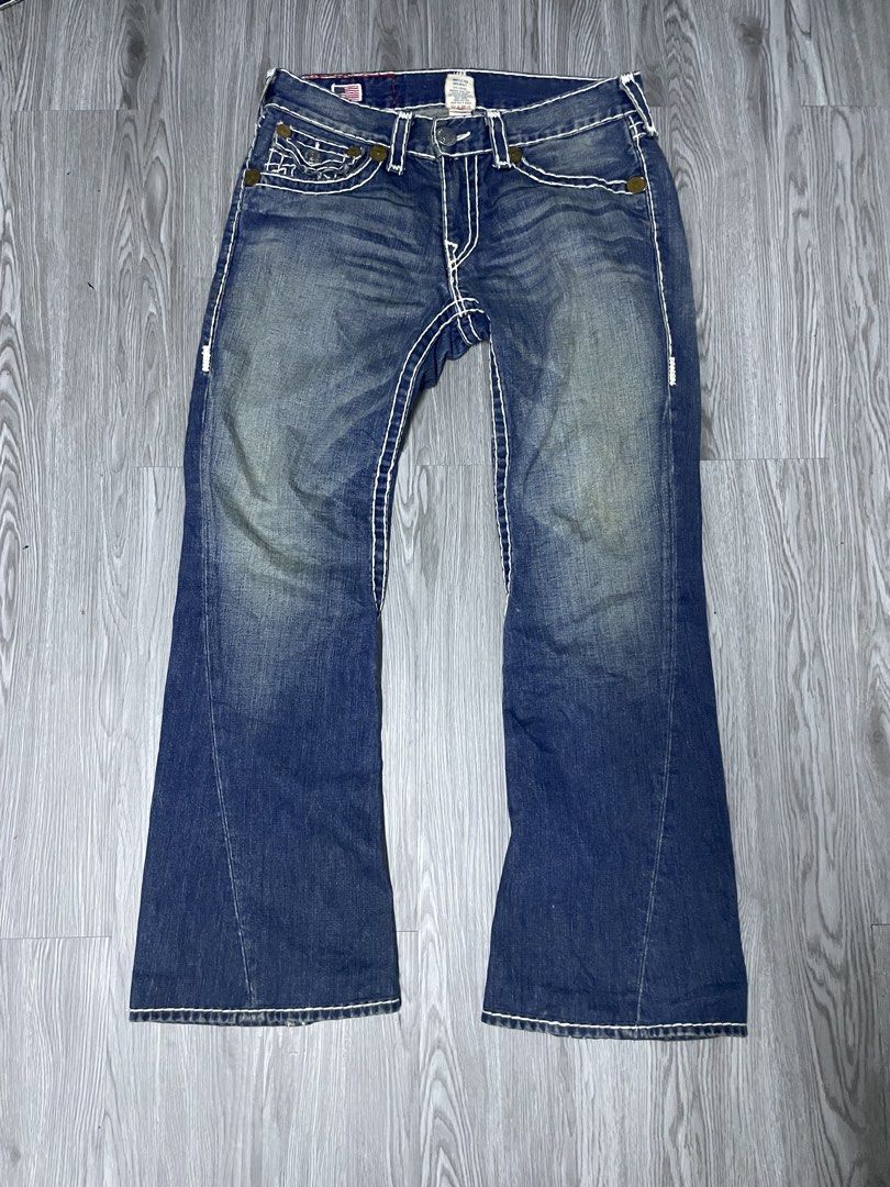 True Religion Flared Jeans White Stitching (Category: Jeans) located in Manila. Submitted by yourfavoriteplug (Listing ID 1462509063, Image 1). Description: - Classic True Religion jeans - Dark wash denim - Iconic white stitching - Flared leg style - Signature horseshoe design on back pockets - Versatile for any occasion.