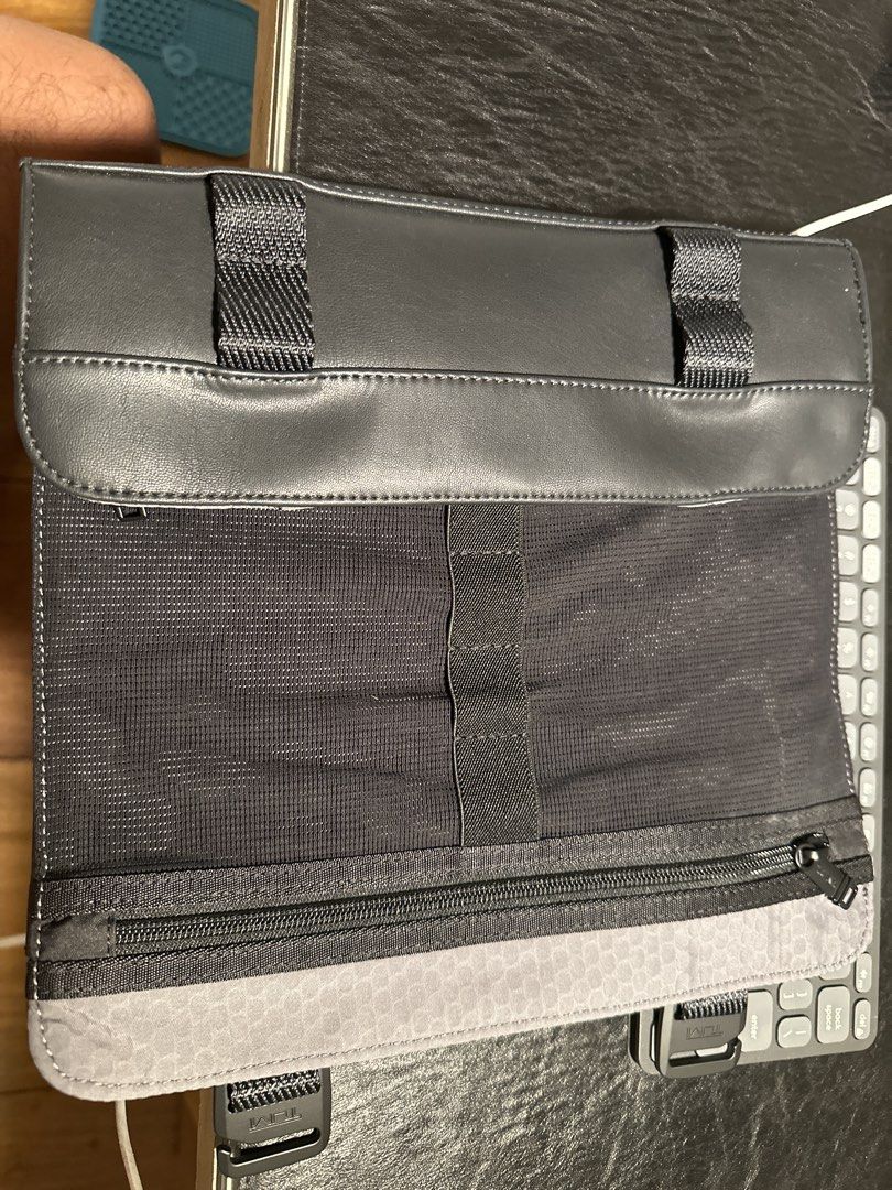 TUMI Leather Travel Organizer Pouch (Category: Belt bags, Clutches and Pouches) located in Makati City. Submitted by victorvillareal (Listing ID 1462616666, Image 2). Description: - Brand: TUMI - Color: Black - Material: Leather and mesh - Closure: Zipped - Features: Multiple internal compartments, external buckle straps - Ideal for: Travel essentials, toiletries, tech accessories.