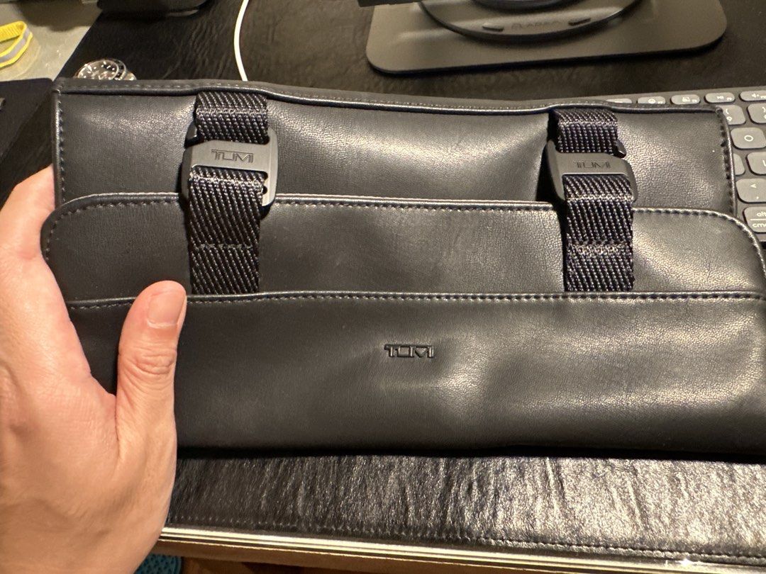 TUMI Leather Travel Organizer Pouch (Category: Belt bags, Clutches and Pouches) located in Makati City. Submitted by victorvillareal (Listing ID 1462616666, Image 1). Description: - Brand: TUMI - Color: Black - Material: Leather and mesh - Closure: Zipped - Features: Multiple internal compartments, external buckle straps - Ideal for: Travel essentials, toiletries, tech accessories.