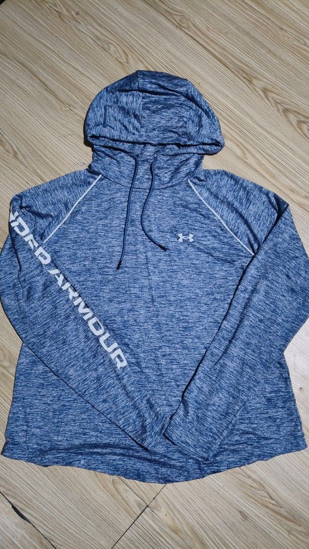Under Armour Blue Heathered Hoodie (Category: Coats, Jackets and Outerwear) located in Manila. Submitted by moneyroll420 (Listing ID 1462458549, Image 1). Description: - Blue heathered hoodie from Under Armour - Features Under Armour logo on chest - Text detail on sleeve - Adjustable drawstring hood - Perfect for workouts or casual wear - Lightweight and comfortable material.