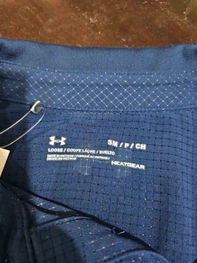 Under Armour Performance Polo Shirt (Category: Formal Shirts) located in Baguio. Submitted by kayeonlineshop (Listing ID 1462534751, Image 3). Description: -blue Under Armour performance polo shirt featuring a subtle micro-grid texture and the brand's logo on the chest -Measurements included in the Photos.