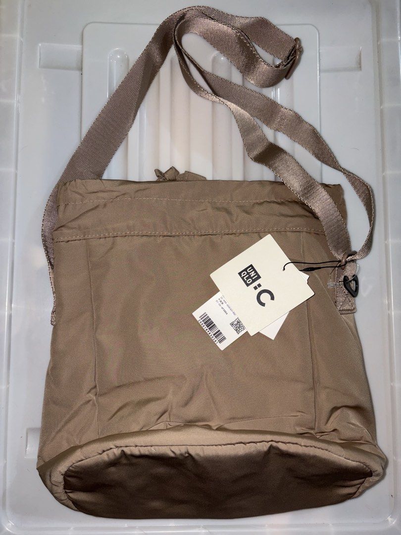 Uniqlo Round Mini Shoulder Bag - Beige (Category: Cross-body Bags) located in Manila. Submitted by cleverwater2528 (Listing ID 1462532931, Image 1). Description: - Uniqlo Round Mini Shoulder Bag - Color: Beige - Brand new with tags attached - Simple and functional design - Adjustable strap for comfortable wear - Spacious enough for your daily essentials - Ideal for everyday use PRICE IS STILL NEGOTIABLE.