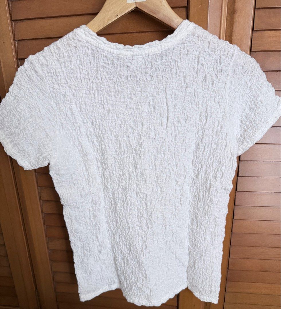Uniqlo White Textured Shirt (Category: Blouses) located in Paranaque City. Submitted by roanclauds (Listing ID 1462541142, Image 2). Description: - Tag removed - Textured fabric all over - Short sleeves and crew neck - Made from a comfortable cotton, nylon, and spandex blend - Stretchy and easy to pair with jeans or skirts - A great basic for any wardrobe.