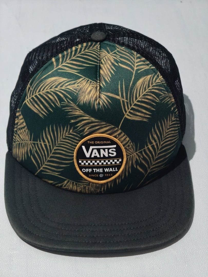 Vans Off The Wall Trucker Cap Palm Leaf Pattern (Category: Caps & Hats) located in Tagum. Submitted by tripthrift2026 (Listing ID 1462624942, Image 1). Description: - Vans trucker cap with a cool palm leaf design - Black mesh back for breathability - Adjustable snapback closure for a custom fit - Made in Vietnam - Ideal for sunny days or adding a stylish touch to any outfit.