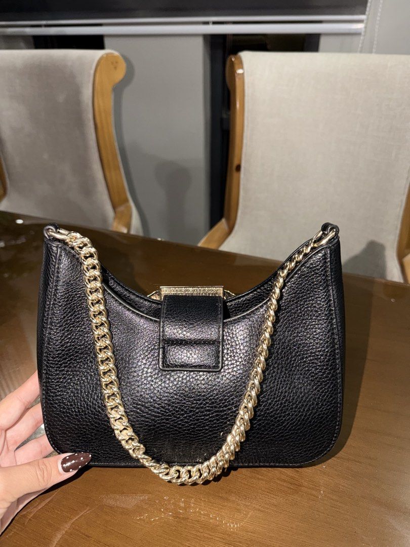Versace Jeans Couture (Category: Shoulder Bags) located in Manila. Submitted by grand.preloved.club (Listing ID 1462646655, Image 2). Description: Authentic Versace Jeans Couture in black with Gold Baroque buckle and chain. • 10/10 Condition • Impulsive buy hehe • super nice in person, good for night out and dinners. • Very classy!! • Never been used as in, super steal. See reference for orig price RFS: Decluttering .