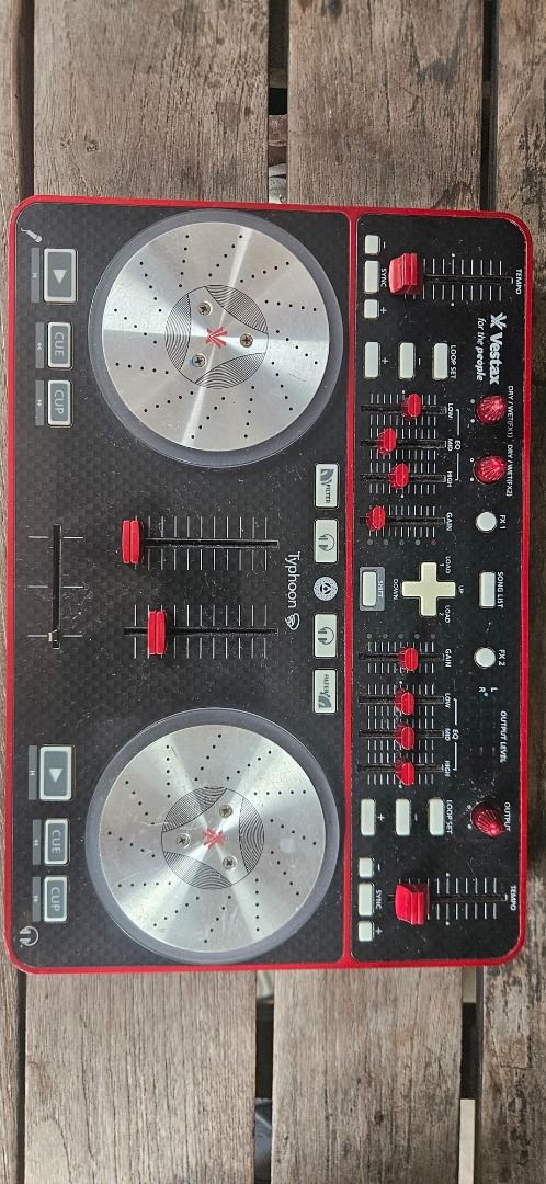 Vestax Typhoon DJ Controller by Numark (Category: Other Audio Equipment) located in Paranaque City. Submitted by negative_view (Listing ID 1462624031, Image 2). Description: - Vestax Typhoon DJ Controller - Excellent working condition - Features two jog wheels and faders for seamless mixing - Includes EQ and gain controls for sound shaping - Loop set function for creative track manipulation - Ideal for aspiring DJs and practice sessions - Reason 