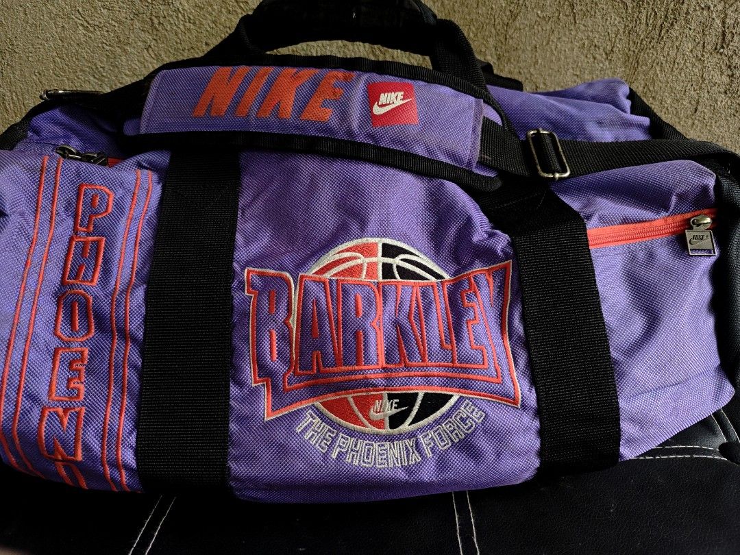 Vintage 1994 NIKE Barkley Phoenix Force Duffle Bag (Category: Sling Bags) located in Ipil. Submitted by ajthriftfinds (Listing ID 1462491353, Image 2). Description: - Cool purple Nike duffel bag - Features Barkley Phoenix Force design - Main compartment - Side zip pocket - Adjustable shoulder strap included - Perfect for gym or travel - Shows some signs of wear, but fully functional.