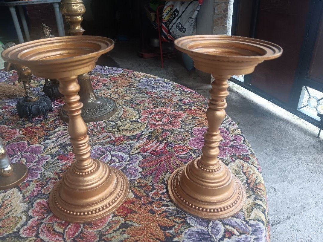 Vintage Brass and Gold Candlesticks Set (Category: Other Home Decor) located in Las Pinas. Submitted by jesus1smysavi0r (Listing ID 1462529236, Image 2). Description: TAKE ALL!!! Set of vintage candlesticks perfect for home decor or special occasions. - Two gold-painted candlesticks with ornate bases. - One darker brass candlestick featuring intricate vine and grape detailing. - One smaller, unique candlestick with frosted and gold bead accents. 