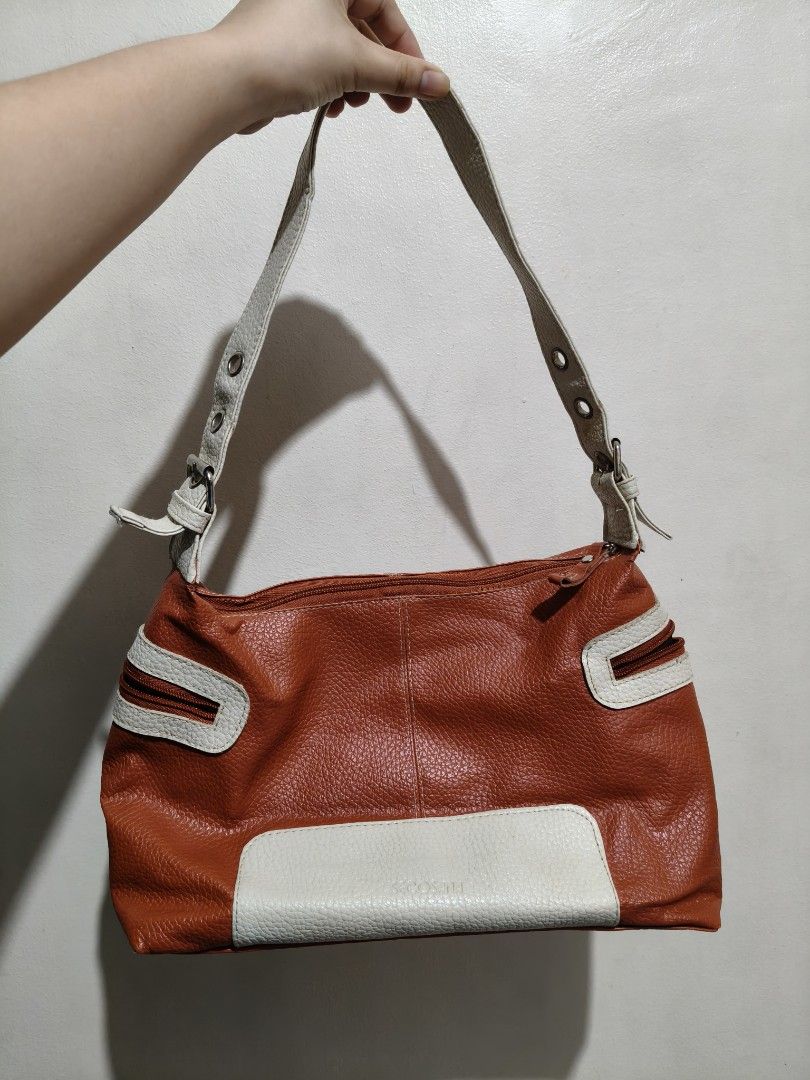 Vintage Leather Shoulder Bag (Category: Shoulder Bags) located in Quezon City. Submitted by giveitalife (Listing ID 1462447505, Image 1). Description: - Cute orange and white shoulder bag - Textured leather material - Front zippered pockets - Main compartment with zipper closure - Interior zippered pocket and slip pocket - Adjustable buckle strap - Minor wear on strap attachment points.