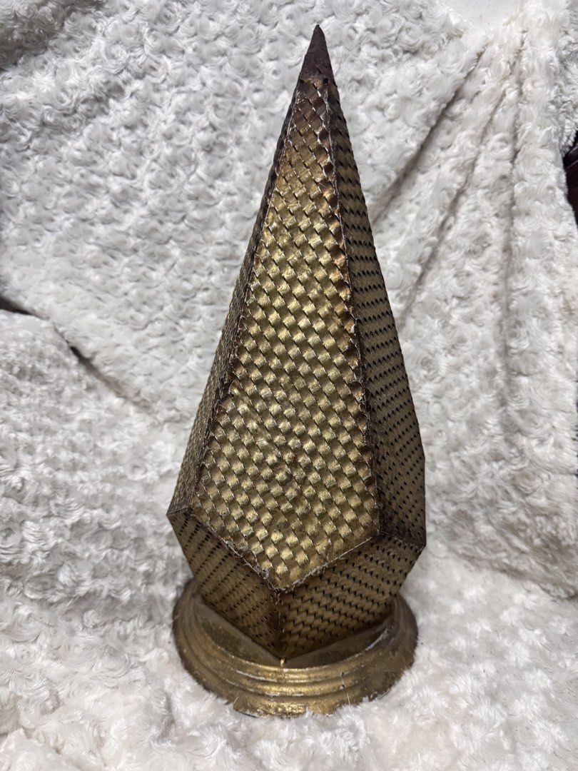 Vintage metal christmas tree (Category: Lighting) located in Marikina City. Submitted by lorradel (Listing ID 1462457472, Image 3). Description: - Unique gold pyramid lamp - Textured geometric pattern - Round, distressed gold base - Slightly pointed, metallic top finish - Creates a vintage, artistic vibe - Ideal for side tables or shelves - issue rusty top part pwedeng irepaint or covered with ornaments.
