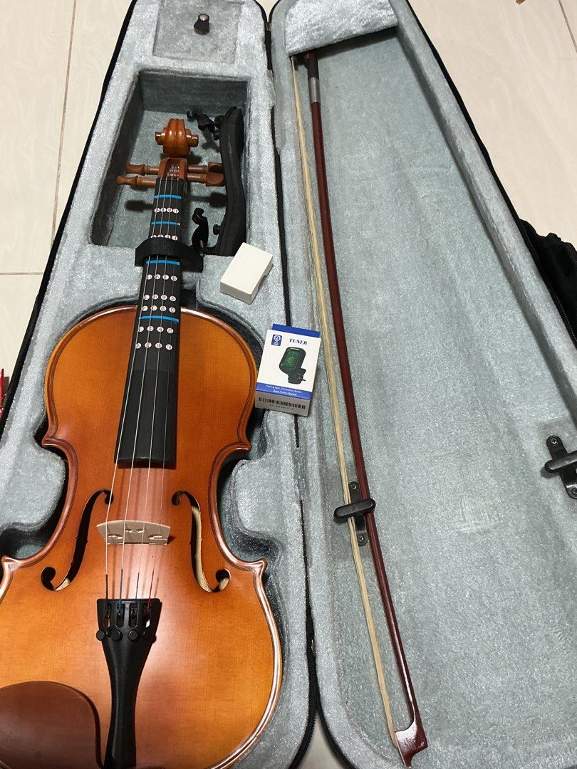 Violin with Bow, Case, and Tuner (Category: Musical Instruments) located in Makati City. Submitted by fazeeee (Listing ID 1462575428, Image 1). Description: - Full violin set: violin, bow, and hard case included. - Bonus clip-on tuner (brand new, still in original packaging). - Perfect for beginners or as a backup instrument. - Ready to play right out of the box. .
