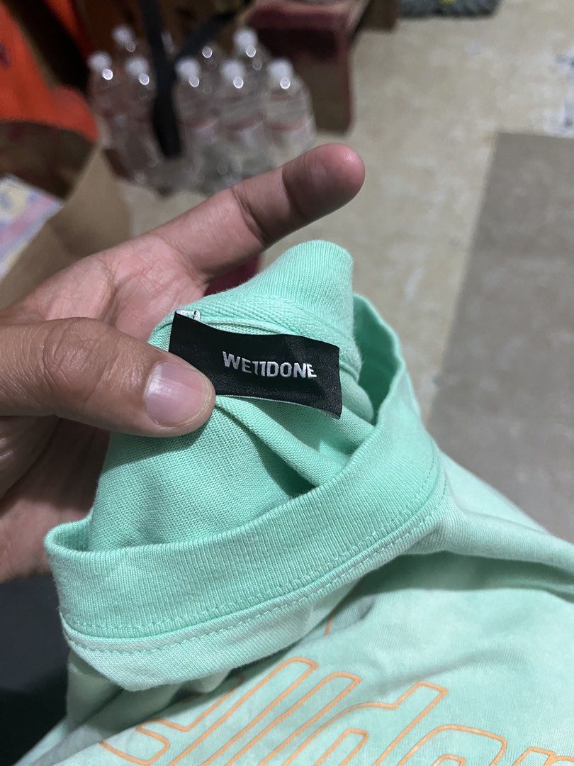 WE11DONE Mint Green Gradient Logo T-Shirt (Category: Tshirts & Polo Shirts ) located in Manila. Submitted by jlogup08 (Listing ID 1462628420, Image 2). Description: - Authentic WE11DONE mint green t-shirt - Features repeated brand logo with gradient effect -XL best fit - **Important:** Hand wash alone to prevent color bleeding - Authenticity verifiable via QR code on tag - Perfect addition to your collection.