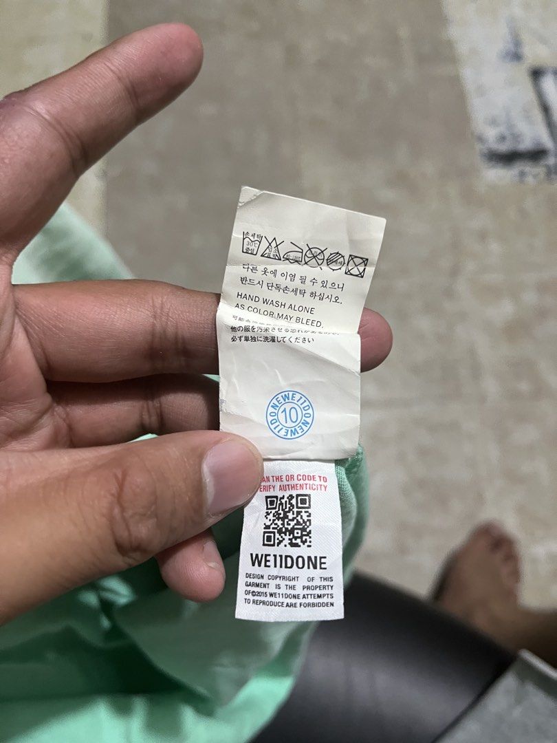 WE11DONE Mint Green Gradient Logo T-Shirt (Category: Tshirts & Polo Shirts ) located in Manila. Submitted by jlogup08 (Listing ID 1462628420, Image 3). Description: - Authentic WE11DONE mint green t-shirt - Features repeated brand logo with gradient effect -XL best fit - **Important:** Hand wash alone to prevent color bleeding - Authenticity verifiable via QR code on tag - Perfect addition to your collection.