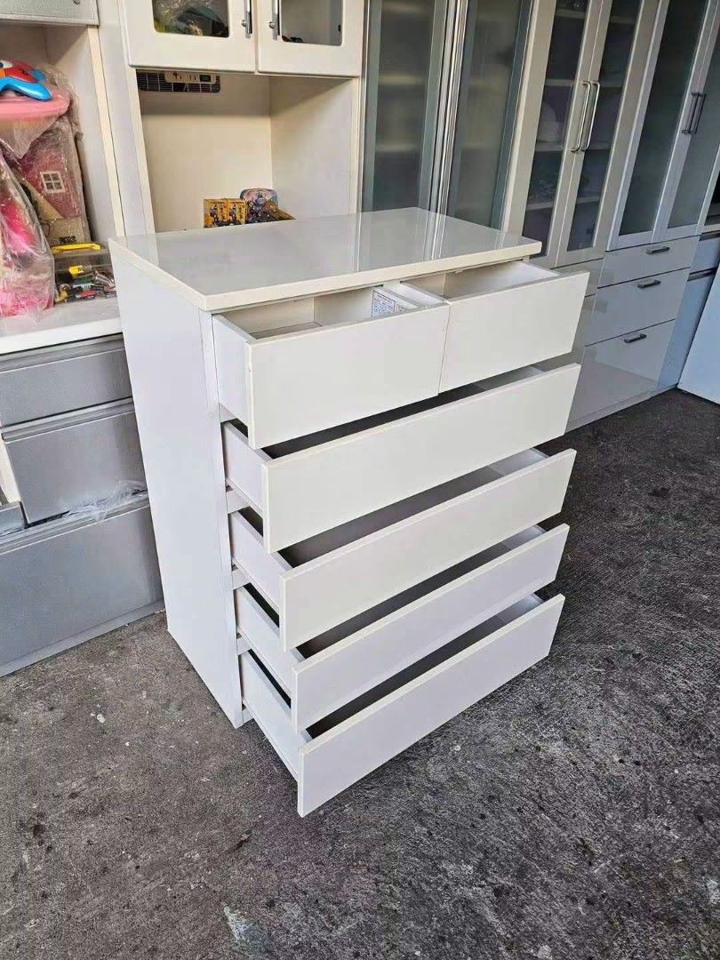 White 6-Drawer Dresser Chest (Category: Shelves, Cabinets & Racks) located in Manila. Submitted by Hezcki (Listing ID 1462606031, Image 2). Description: - White dresser with 6 drawers - Top two drawers are smaller - Plenty of storage space for clothes and other items - Simple and clean design - Fits well in most rooms.
