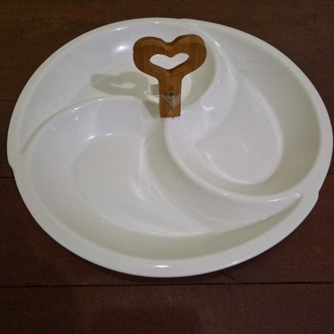 White Ceramic 3-Section Serving Plate with Wooden Heart Handle (Category: Other Kitchenware & Tableware) located in Quezon City. Submitted by bravewaters (Listing ID 1462592663, Image 1). Description: White ceramic 3-section serving plate with wooden heart-shaped handle. Great for appetizers, snacks, sauces, nuts, or side dishes. Clean and simple design for everyday dining or entertaining. - 3 compartments - Ceramic plate with wooden handle.