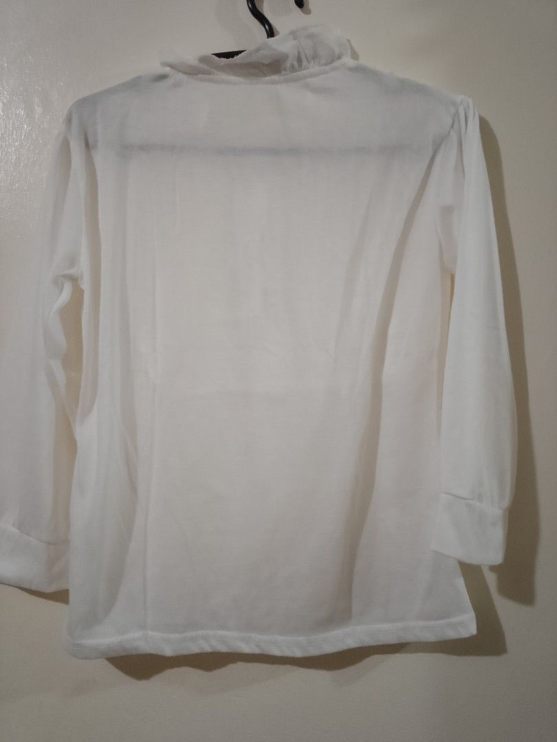 White Collared Blouse with Ruffle Neck and Button Front (Category: Babies & Kids Fashion) located in Cavite. Submitted by rodrycuteshop (Listing ID 1462643218, Image 2). Description: - Classic white long-sleeved blouse - Elegant ruffled collar - Button-up front with subtle pleat details - Cuffed sleeves for a polished look - Perfect for both casual outings and semi-formal events - Used as a costume for prince.