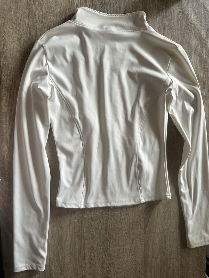 White High Neck Zip Up Jacket & Cargo Pants Set (Category: Sets or Coordinates) located in Cainta. Submitted by thingsfromerika (Listing ID 1462473262, Image 3). Description: - White long sleeve zip-up jacket with high neck - Thumbholes on sleeves for extra comfort - Matching white cargo pants - Elastic waistband for a flexible fit - Small green heart detail on cargo pocket - Comfortable and stylish matching set.