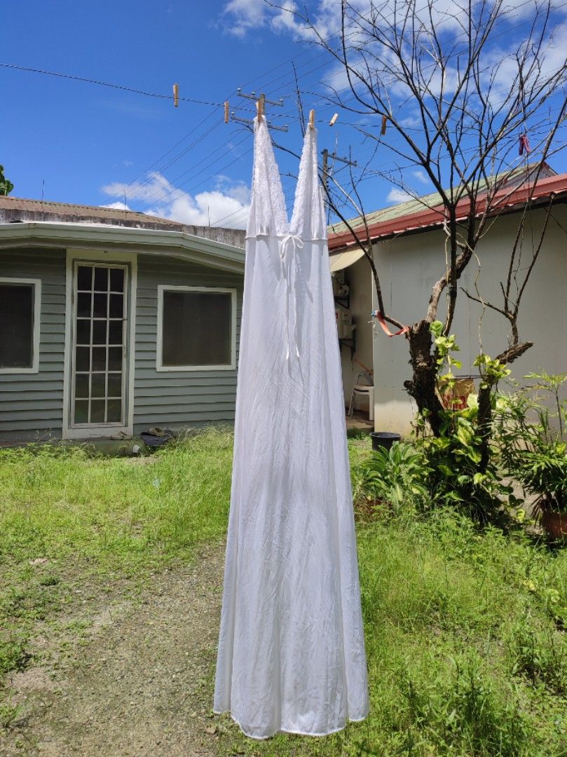 White Lace Trimmed Maxi Nightgown (Category: Undergarments & Loungewear) located in Jaen. Submitted by roxantiago (Listing ID 1462671180, Image 1). Description: - Long white nightgown - Silky fabric that drapes nicely - Features delicate lace trim on V-neckline and straps - Adjustable tie detail at the bust - Perfect for comfortable lounging or sleeping - Adds a touch of vintage charm to your sleepwear S to M flaw: faint blue stains. see photos .