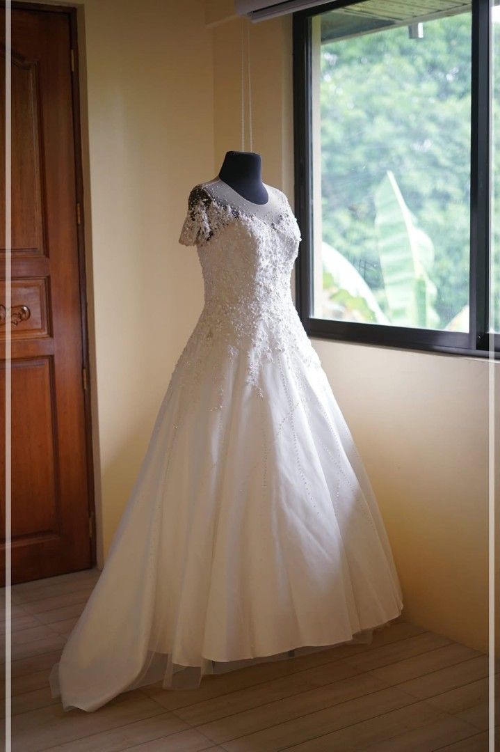 White Lace Wedding Dress with Long Train (Category: Evening dresses & gowns) located in Manila. Submitted by safetree-c89cdb (Listing ID 1462494765, Image 2). Description: - Elegant white wedding gown - Intricate lace detailing on bodice and sleeves - Full skirt with a dramatic long train - Includes a complimentary bouquet - Ready to make your special day unforgettable.