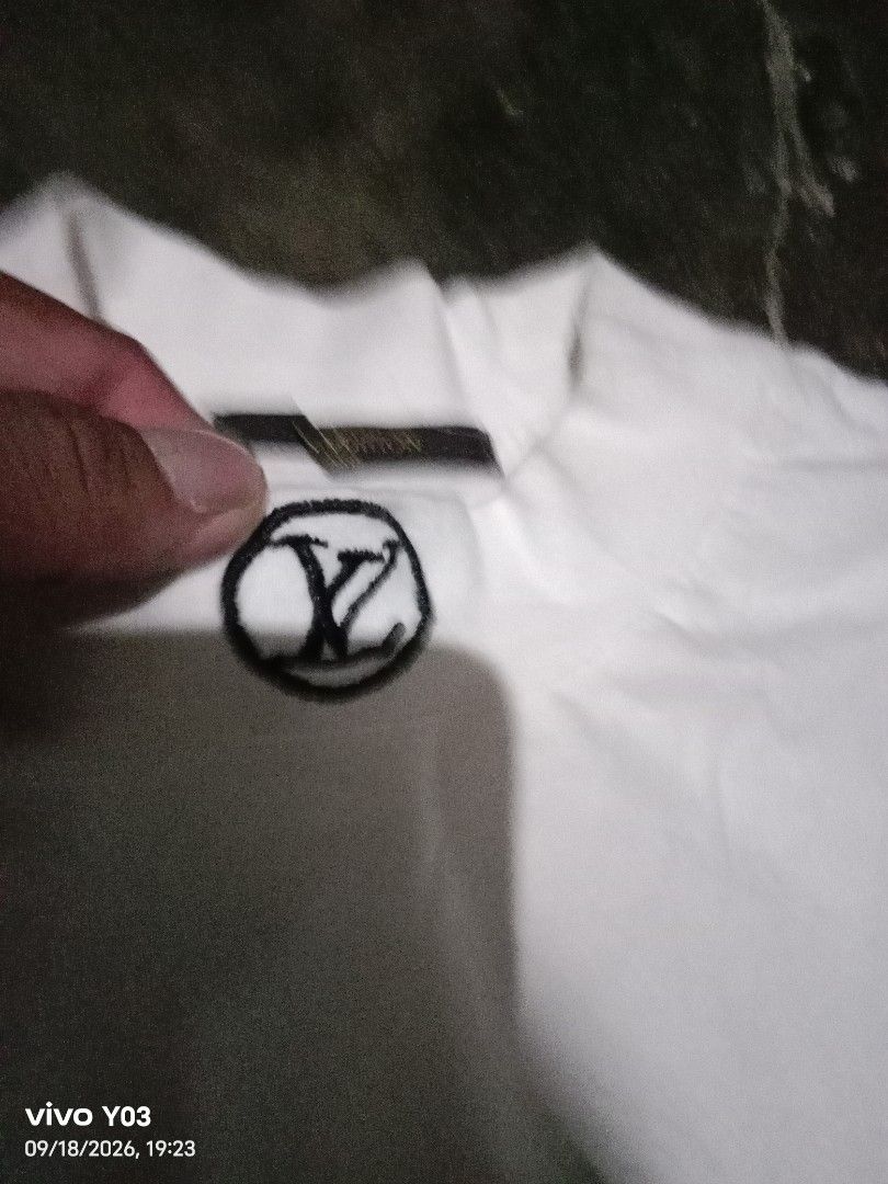 White Louis Vuitton Monogram T-Shirt (Category: Tshirts & Polo Shirts ) located in Cabuyao City. Submitted by blake657 (Listing ID 1462582098, Image 2). Description: - Classic white crew neck t-shirt - Features a small, embroidered Louis Vuitton monogram logo on the chest - Simple and clean design - Ideal for casual wear.