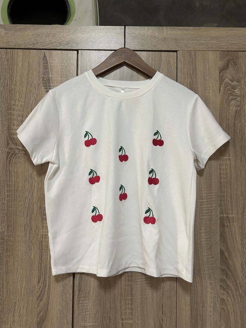 White shirt (Category: Shirts) located in Bulacan. Submitted by relove.re (Listing ID 1462583173, Image 1). Description: - white top and shirt - with printed cherry graphic art - soft fabric - good for out and about .