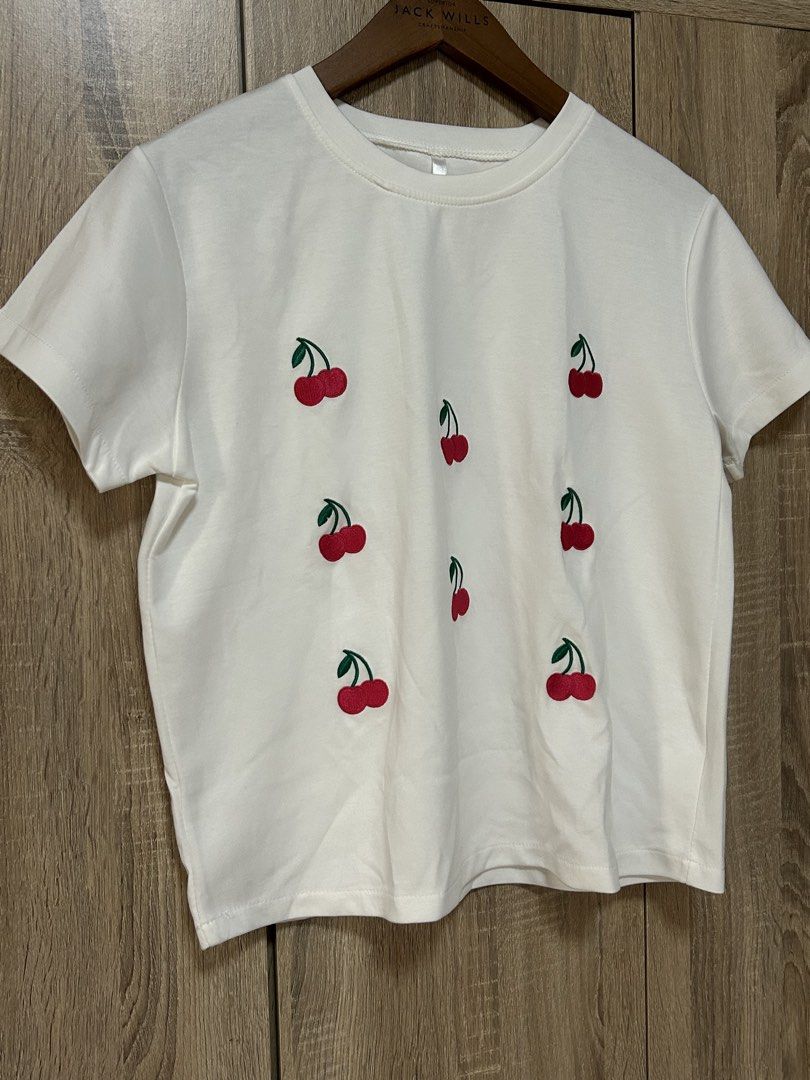 White shirt (Category: Shirts) located in Bulacan. Submitted by relove.re (Listing ID 1462583173, Image 3). Description: - white top and shirt - with printed cherry graphic art - soft fabric - good for out and about .