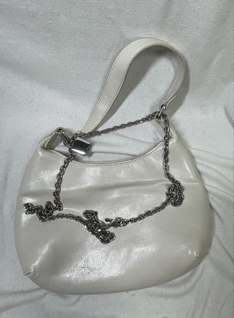 White Shoulder Bag with Chain Detail (Category: Shoulder Bags) located in Mandaluyong City. Submitted by coolmeybab (Listing ID 1462514032, Image 1). Description: - Stylish white shoulder bag from URBAN REVIVO - Elegant silver chain strap - Cute padlock detail on the front - Interior zip pocket and slip pocket for organization - Compact size, ideal for carrying essentials.