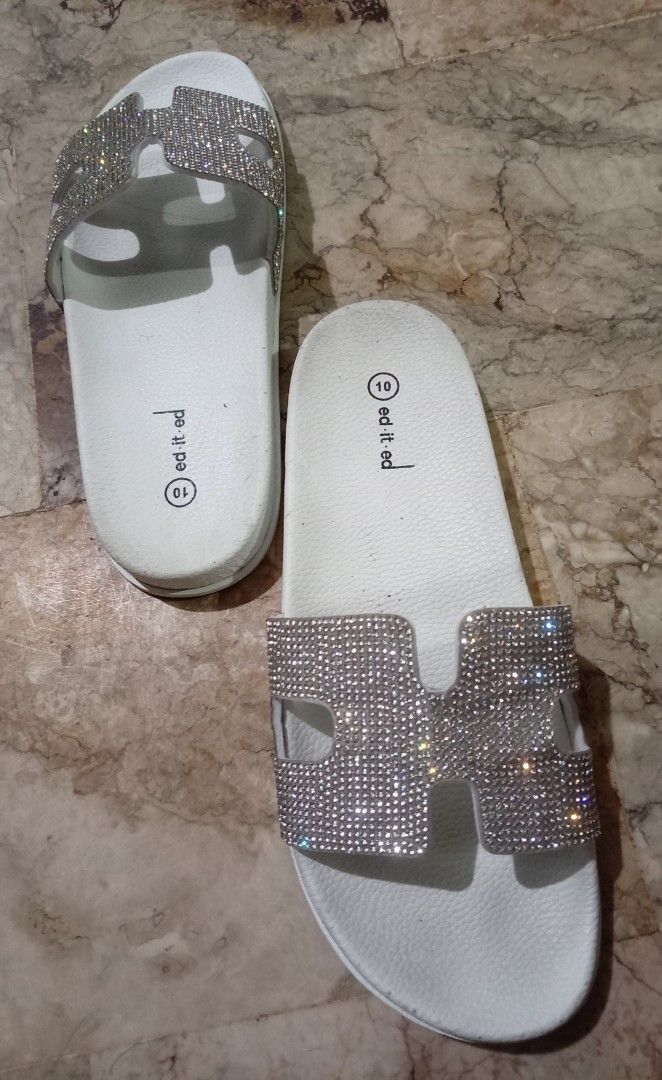 White Slides with Rhinestone H Detail (Category: Slippers and slides) located in Quezon City. Submitted by chacha30.s (Listing ID 1462562463, Image 2). Description: - Chic white slip-on slides - Embellished with sparkly rhinestone 'H' detail on the strap - Comfortable for everyday wear - Size: 10 - Soles have some signs of wear, but plenty of life remaining - Perfect for casual outing . Text me at 09277152134 . Buy na po kayo/Offer lang po kayooo