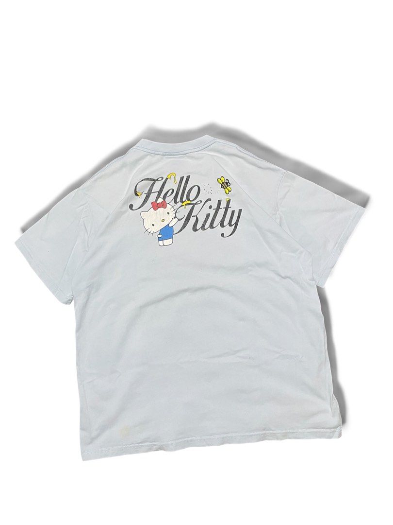WHO'Sée Hello Kitty T-shirt Light Blue (Category: Shirts) located in Munoz. Submitted by bb_jimbo0 (Listing ID 1462626194, Image 2). Description: - Light blue t-shirt - Features 'WHO'Sée' graphic on the front - Adorable Kitty and bee graphic on the back - Made from soft, comfortable material - Perfect for casual everyday wear - Please check photos for detailed views.