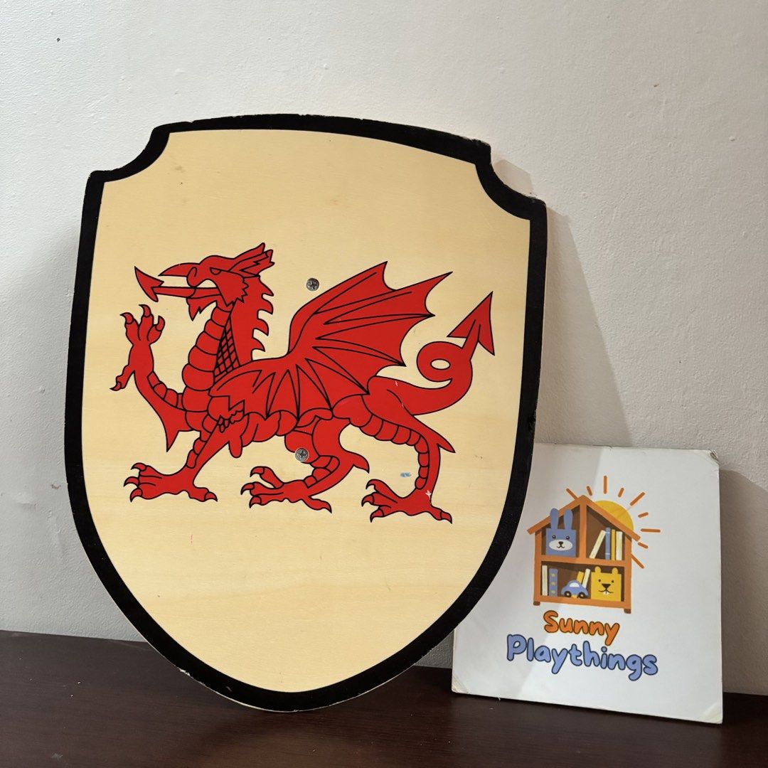Wooden Dragon Shield Toy (Category: Kids Toys) located in Taguig. Submitted by sunnyplaythingsph (Listing ID 1462478360, Image 1). Description: - Cool wooden shield with a red dragon design. - Great for pretend play and costumes. - Made of durable wood with a black trim. - Perfect for any little knight or dragon enthusiast. - Fun for kids' parties or imaginative play..