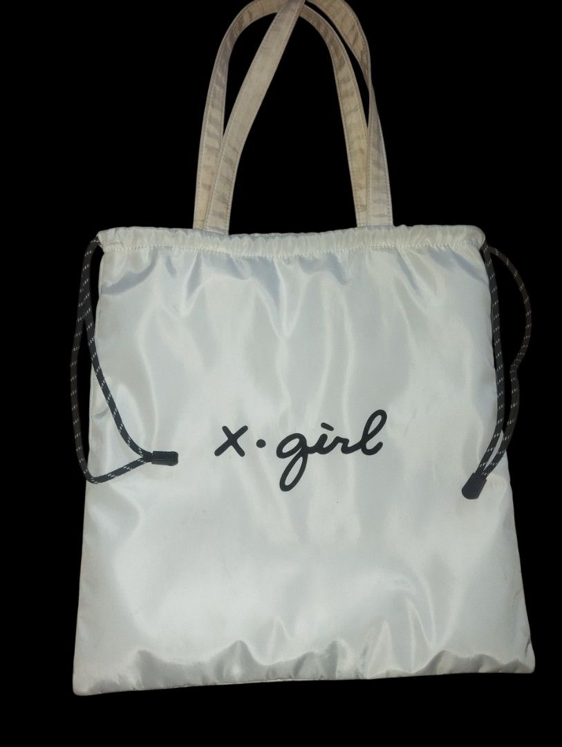 X-girl White Drawstring Tote Bag (Category: Tote Bags) located in Manila. Submitted by thriftjepo01336 (Listing ID 1462521092, Image 1). Description: - White X-girl tote bag - Drawstring closure on the sides - Two handles for carrying - Simple and functional design - Ideal for everyday use - Easy to pack and carry essentials.