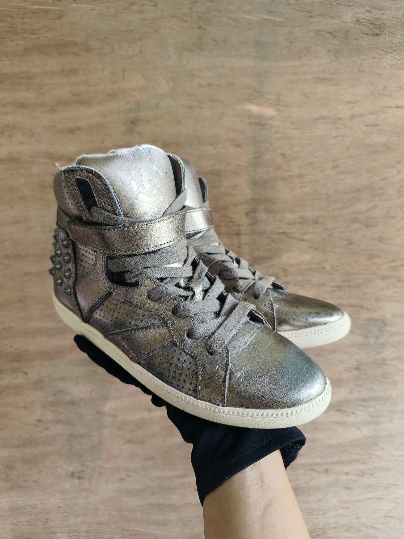 Y2k ASH Gold Studded High-Top Sneakers with Strap (Category: Sneakers) located in Davao. Submitted by vndrgd (Listing ID 1462450962, Image 3). Description: - Eye-catching gold high-top sneakers - Features a strap closure for a secure fit - Bold stud embellishments on the back - Stylish perforated details on the sides - Classic lace-up front closure - Unique design for a statement-making look.
