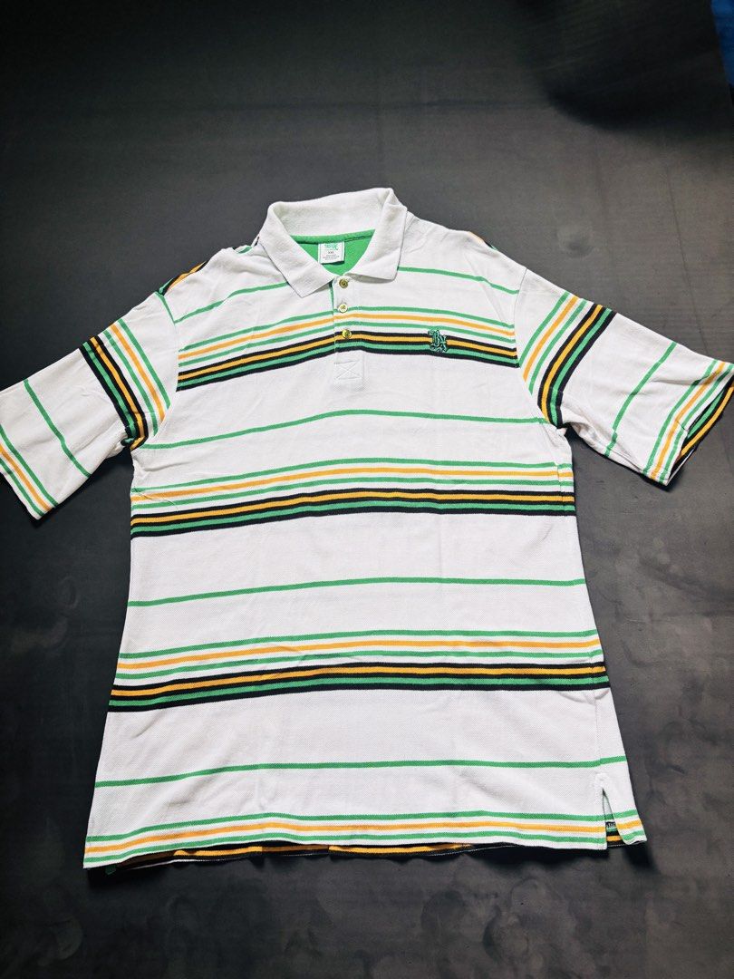 Y2k Vibes Polo Shirt (Category: Tshirts & Polo Shirts ) located in Manila. Submitted by erxm.thrift (Listing ID 1462572700, Image 1). Description: - Classic white polo shirt - Horizontal stripes in green, yellow, and black - Small embroidered logo on chest - Traditional collar and button-up closure - Short sleeves with striped cuffs - Ideal for casual wear.