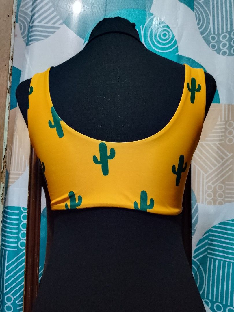 Yellow Cactus Print Bikini Top with Tie Front (Category: Bikinis & Swimsuits) located in Batangas. Submitted by sheenx.09 (Listing ID 1462497669, Image 2). Description: - S on tag (xs to s) - Adorable yellow bikini top 😍 - Fun green cactus print 😊 - Stylish tie-front detail - Chic cutout design 😚 - Comfortable and fashionable - Versatile: pairs with any bikini bottoms 😀 - Ideal for beach or pool days.