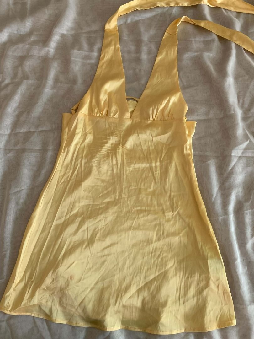 Yellow Silk Halter Dress (Category: Dresses) located in Paranaque City. Submitted by juliaaafona (Listing ID 1462508792, Image 3). Description: - Yellow halter neck dress - Flattering V-neckline - Fabric with a slight sheen - Midi length - Has a small stain .