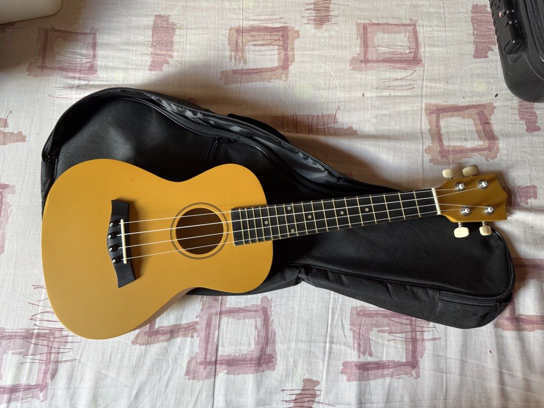Yellow Ukulele with Black Gig Bag (Category: Musical Instruments) located in Mandaluyong City. Submitted by itsme_nini (Listing ID 1462488503, Image 1). Description: - Bright yellow ukulele - Includes black gig bag for easy transport - Ideal for beginners or new musicians - Features white tuning pegs - Ready for its new owner!.