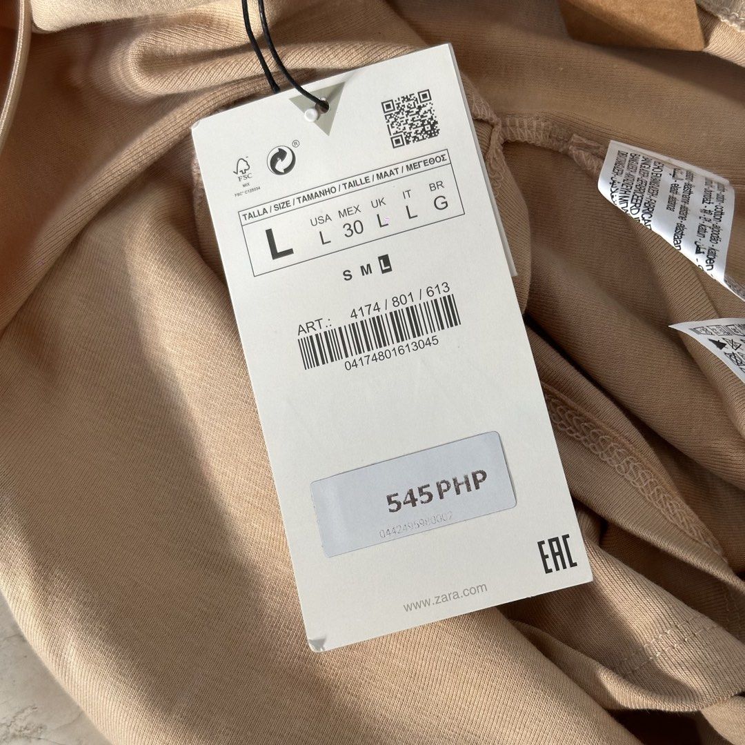 ZARA Beige Crop Top (Category: Sleeveless) located in Lapu Lapu. Submitted by pangayamph (Listing ID 1462670717, Image 3). Description: - Zara Beige Crop Top - Spaghetti Straps - Size: L - Material: 95% Cotton, 5% Elastane - Made in Bangladesh - Perfect basic piece, easy to style with anything!.