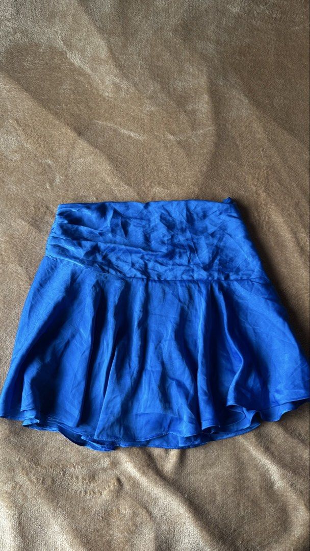 Zara Blue Satin Mini Skirt (Category: Skirts) located in Mandaluyong City. Submitted by yv.stuff (Listing ID 1462481739, Image 2). Description: - Zara blue satin mini skirt - High-waisted design - Flowy, pleated style - Perfect for dressing up or down - Ideal for summer nights or casual days - Easy to pair with various tops and heels.