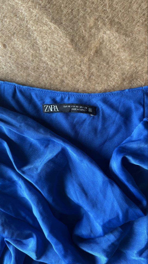 Zara Blue Satin Mini Skirt (Category: Skirts) located in Mandaluyong City. Submitted by yv.stuff (Listing ID 1462481739, Image 3). Description: - Zara blue satin mini skirt - High-waisted design - Flowy, pleated style - Perfect for dressing up or down - Ideal for summer nights or casual days - Easy to pair with various tops and heels.