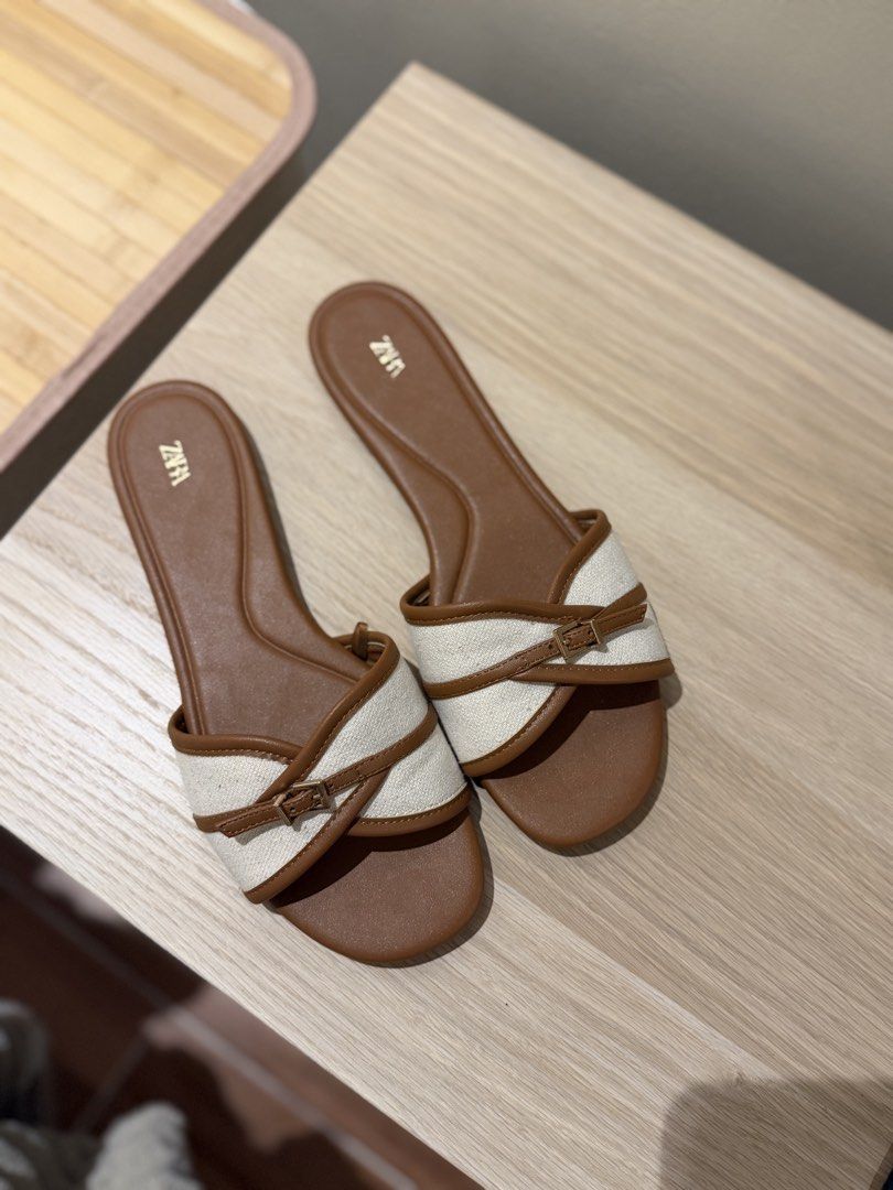 ZARA Flat Sandals Size 39 (Category: Flats & Sandals) located in Pasig City. Submitted by lux08 (Listing ID 1462628084, Image 1). Description: - Brand: ZARA - Type: Slide Sandals - Color: Brown and White - Size: 39 - Condition: Soles show minimal wear (used 2x only - mall errands) .