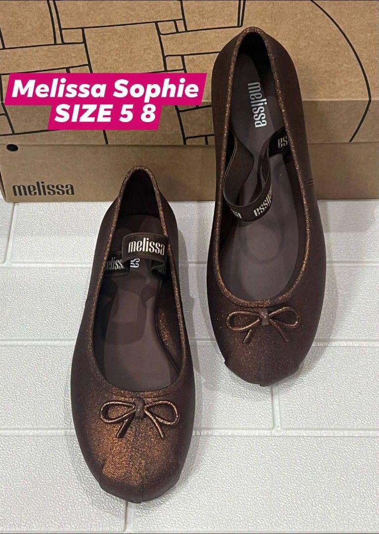 100% ORIGINAL MELISSA (Category: Flats & Sandals) located in Manila. Submitted by mydytrends (Listing ID 1462856570, Image 1). Description: - 100% Original Melissa Sophie flats - Color: Bronze with subtle shimmer - Size: 8 - Material: Signature Melissa jelly - Features a cute bow detail and elastic strap for secure fit.