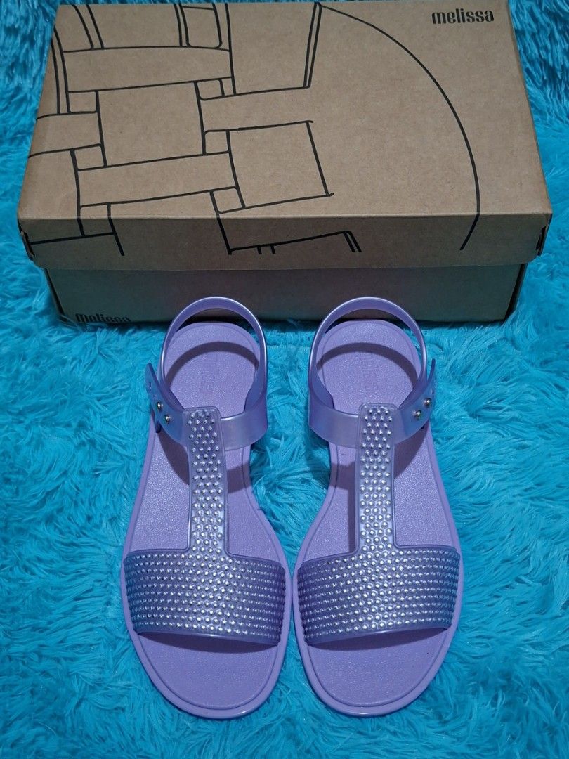 100% ORIGINAL MELISSA (Category: Flats & Sandals) located in Manila. Submitted by mydytrends (Listing ID 1462858237, Image 2). Description: NEGO PRICE FOR SURE MINER 🥰 BIG DISCOUNT 🥰 - 100% Original Melissa Sandals - Color: Lavender - Size: EU 37 / UK 4 / US 6 - Features sparkling rhinestone embellishments on the T-strap - Made from signature Melissa jelly material.