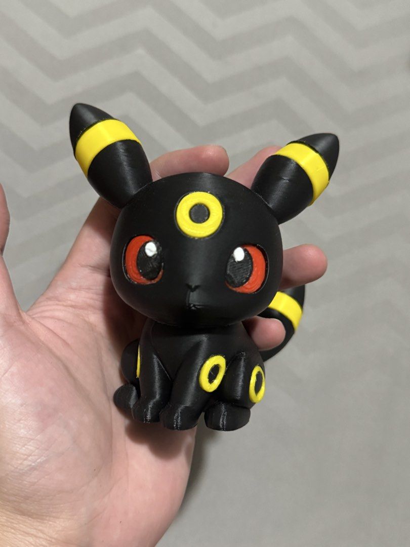 3D Printed Umbreon Pokemon Figure (Category: Figurines & Statues) located in Pasay City. Submitted by pokeflix (Listing ID 1462841044, Image 2). Description: - Adorable Umbreon Pokemon figure - Features classic black body with yellow accents and striking red eyes - Approximately palm-sized, ideal for desks or shelves - A must-have for any Pokemon enthusiast - Please note: Minor layer lines visible due to 3D printing process.