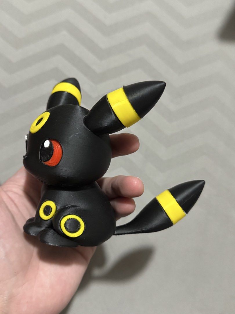 3D Printed Umbreon Pokemon Figure (Category: Figurines & Statues) located in Pasay City. Submitted by pokeflix (Listing ID 1462841044, Image 3). Description: - Adorable Umbreon Pokemon figure - Features classic black body with yellow accents and striking red eyes - Approximately palm-sized, ideal for desks or shelves - A must-have for any Pokemon enthusiast - Please note: Minor layer lines visible due to 3D printing process.
