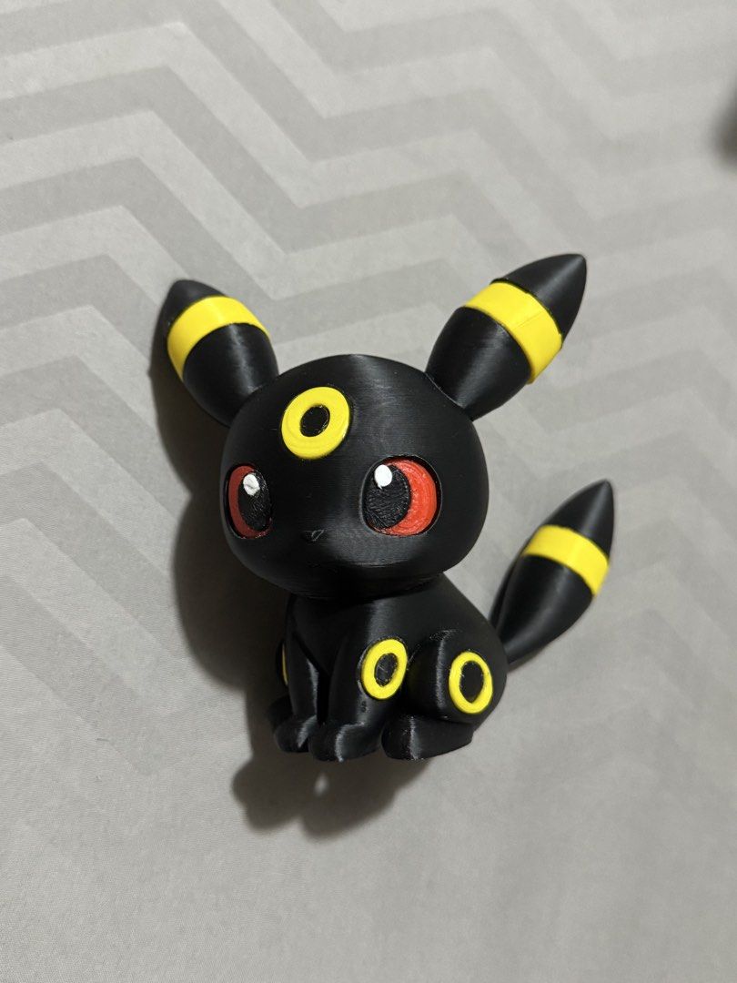 3D Printed Umbreon Pokemon Figure (Category: Figurines & Statues) located in Pasay City. Submitted by pokeflix (Listing ID 1462841044, Image 1). Description: - Adorable Umbreon Pokemon figure - Features classic black body with yellow accents and striking red eyes - Approximately palm-sized, ideal for desks or shelves - A must-have for any Pokemon enthusiast - Please note: Minor layer lines visible due to 3D printing process.