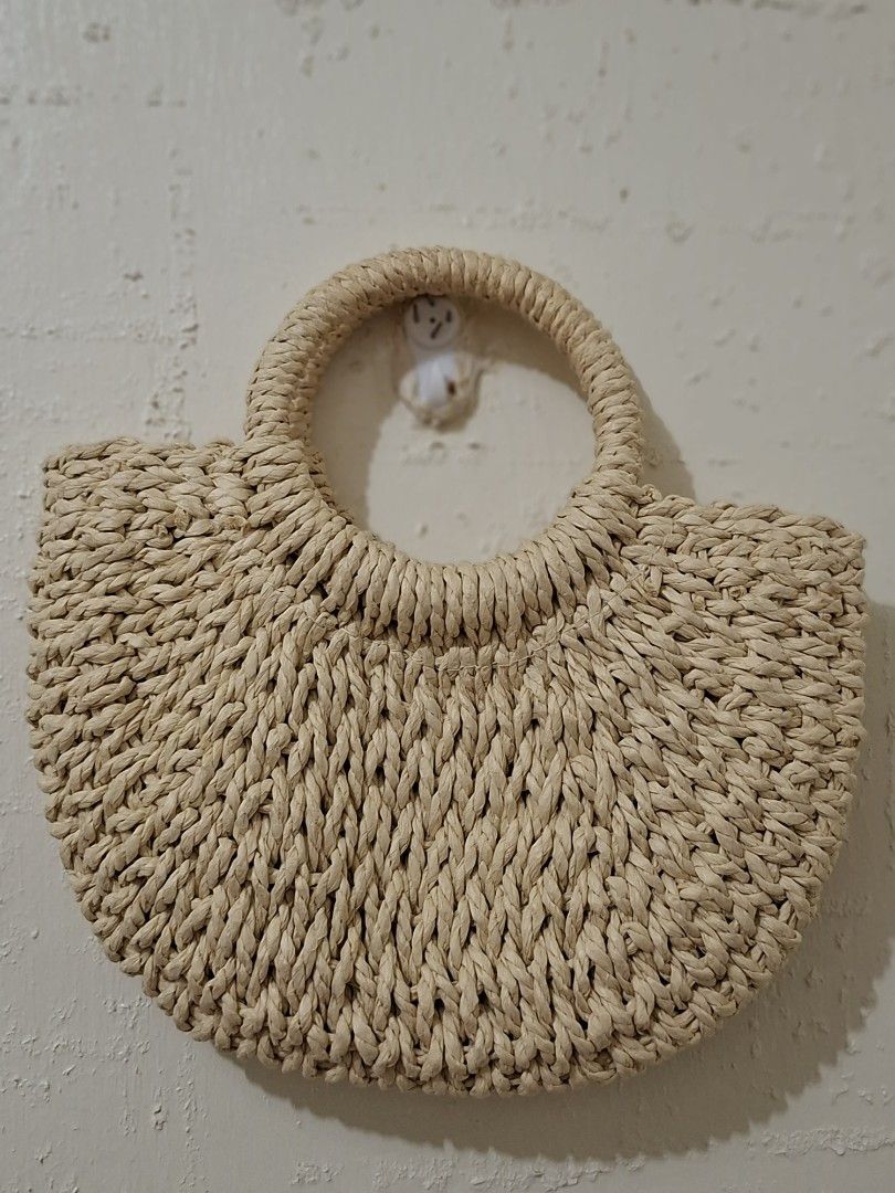 A beige half moon shaped handbag (Category: Purses & Pouches) located in Caloocan City. Submitted by pvaliao (Listing ID 1462846708, Image 2). Description: A beige hand woven paper-rope, half-moon handbag with a circular top handle. Pre-owned Size: 10 inches × 7 inches Buy it now 😊 80 pesos only.