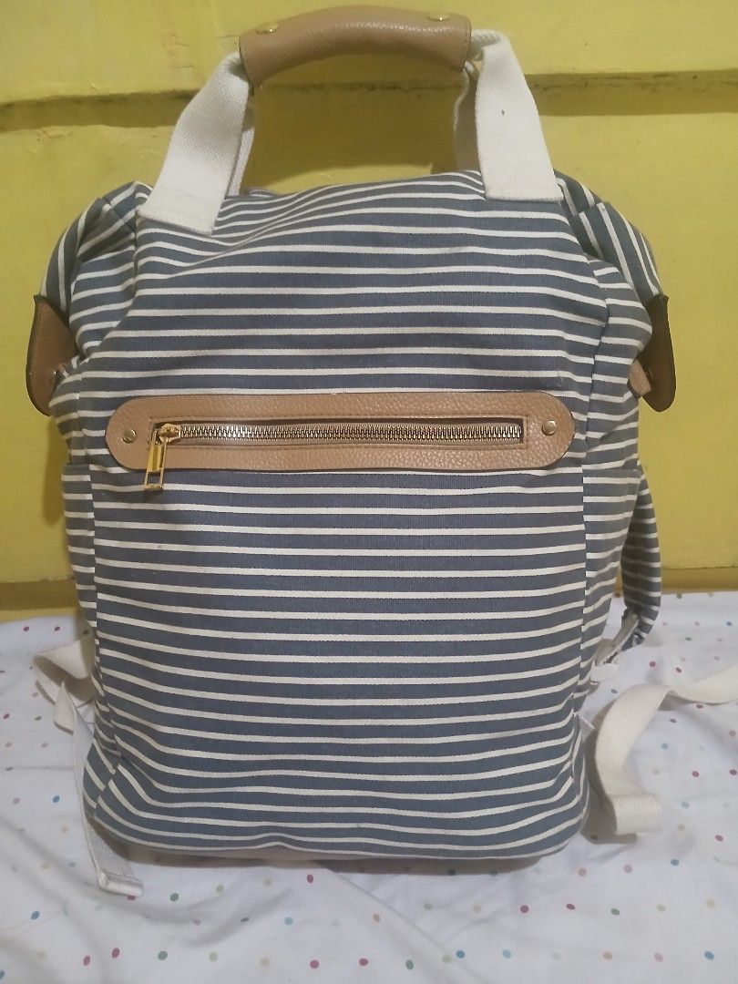 A New Day Striped Canvas Convertible Backpack (Category: Backpacks) located in Pasig City. Submitted by Seller01 (Listing ID 1462821098, Image 1). Description: A New Day Striped Canvas Convertible Backpack. Height: ~13 to 14 inches Width: ~11 to 12 inches Depth: ~4.5 to 5 inches Like new,Padala galing Us. Di pa nagamit nakatambak lang. Issue: May minimal scratch lang sa likod , Please check the photos..